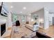 Cozy living room with a fireplace, hardwood floors, and ample natural light at 105 Wittenham Dr, Cary, NC 27519