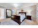 Comfortable main bedroom with a large mirror, and carpeted floors with a view of the walk in closet at 105 Wittenham Dr, Cary, NC 27519