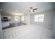 Bright living room with neutral colors, a ceiling fan, and large windows provide ample natural light and air flow at 109 Ambergate Ct, Rocky Mount, NC 27804