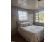 Bedroom featuring a cozy bed with soft linens, complemented by natural light from the two windows at 109 Stephens St, Chapel Hill, NC 27516