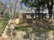 View of a charming home with a stone wall featuring '109 Stephens Street' and steps leading up to the house at 109 Stephens St, Chapel Hill, NC 27516