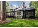 Large backyard featuring a deck with pergola, stone chimney, and manicured lawn at 1120 Berwyn Way, Raleigh, NC 27615