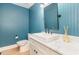 Stylish powder room with blue beadboard paneling, modern vanity, and vessel sink for a chic, updated look at 1120 Berwyn Way, Raleigh, NC 27615