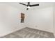Minimalist bedroom with soft carpeting, a ceiling fan, natural light, and neutral walls offering a blank canvas at 1120 Berwyn Way, Raleigh, NC 27615
