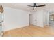Spacious bedroom with light hardwood floors, ceiling fan, ensuite bath, and a neutral color palette at 1120 Berwyn Way, Raleigh, NC 27615