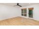 Bright bedroom with hardwood flooring, a ceiling fan, and a door leading to a private outdoor balcony at 1120 Berwyn Way, Raleigh, NC 27615
