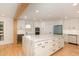 Bright, spacious kitchen features a marble island, white cabinetry, stainless appliances, and wood beam accents at 1120 Berwyn Way, Raleigh, NC 27615