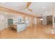 Open concept living room featuring a kitchen, fireplace, wood floors and natural lighting at 1120 Berwyn Way, Raleigh, NC 27615