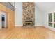 Spacious living room featuring a stone fireplace, hardwood floors, and an open layout at 1120 Berwyn Way, Raleigh, NC 27615