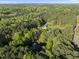 Drone shot showing a home tucked away in a tranquil, wooded setting at 13 Crosswinds Estates Dr, Pittsboro, NC 27312