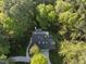 Stunning aerial view of home surrounded by lush, mature trees and a long driveway at 13 Crosswinds Estates Dr, Pittsboro, NC 27312