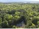 Beautiful wooded lot with pond; home is nestled in a serene and private forest setting at 13 Crosswinds Estates Dr, Pittsboro, NC 27312