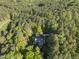 Beautiful wooded lot featuring a home and long driveway, all surrounded by dense trees at 13 Crosswinds Estates Dr, Pittsboro, NC 27312