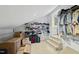 Finished attic space offering extra storage with clothing racks and shelving next to carpeted stairs at 13 Crosswinds Estates Dr, Pittsboro, NC 27312