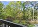 Relaxing view of the wooded backyard from the upper deck at 13 Crosswinds Estates Dr, Pittsboro, NC 27312