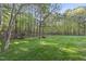 Picture of the spacious, well-kept backyard, featuring a swing and wooden fence at 13 Crosswinds Estates Dr, Pittsboro, NC 27312
