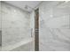 Modern bathroom featuring elegant marble tiling, a built-in shower bench and a rainfall shower head at 13 Crosswinds Estates Dr, Pittsboro, NC 27312