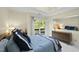 Inviting bedroom showcasing a large window, comfortable bed and elegant dresser at 13 Crosswinds Estates Dr, Pittsboro, NC 27312