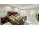 Spacious bedroom featuring a wood bed frame and a colorful, patterned quilt at 13 Crosswinds Estates Dr, Pittsboro, NC 27312