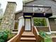 View of the home entrance, stone chimney, and a small balcony at 13 Crosswinds Estates Dr, Pittsboro, NC 27312