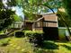 Exterior view of a home with a deck, lush green yard, and mature trees at 13 Crosswinds Estates Dr, Pittsboro, NC 27312
