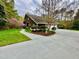 Beautiful home featuring a well-manicured lawn, mature landscaping and attached garages at 13 Crosswinds Estates Dr, Pittsboro, NC 27312