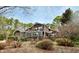 Two-story home with wood siding, a balcony, and wintery landscaping at 13 Crosswinds Estates Dr, Pittsboro, NC 27312