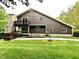Charming two-story home with stone chimney and wood siding at 13 Crosswinds Estates Dr, Pittsboro, NC 27312