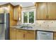 Kitchen showcasing stainless steel appliances, granite countertops, and wood cabinetry at 13 Crosswinds Estates Dr, Pittsboro, NC 27312