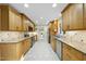 Bright kitchen featuring wood cabinets, granite countertops, stainless appliances and tile flooring at 13 Crosswinds Estates Dr, Pittsboro, NC 27312