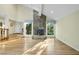 This living room features a stone fireplace, hardwood floors, and an abundance of natural light at 13 Crosswinds Estates Dr, Pittsboro, NC 27312