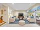 Staged living room with a large area rug, neutral furniture and an accent ottoman at 13 Crosswinds Estates Dr, Pittsboro, NC 27312