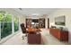 Office features a large window, bookshelves, a modern desk with an executive chair, and stylish decor at 13 Crosswinds Estates Dr, Pittsboro, NC 27312