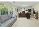 Home office with large windows, comfortable couch, and well-lit desk area at 13 Crosswinds Estates Dr, Pittsboro, NC 27312