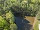 Pictureseque wooded lot featuring a tranquil pond with fountain nestled among lush, mature trees at 13 Crosswinds Estates Dr, Pittsboro, NC 27312
