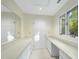 Bright dressing area with built-in vanity, mirrors and natural light from a large window at 13 Crosswinds Estates Dr, Pittsboro, NC 27312