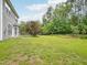 Spacious backyard featuring a well-manicured lawn and mature trees, perfect for outdoor activities at 13 Pegram Ct, Durham, NC 27703