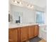 Bright bathroom featuring double sinks, vanity, and a tub with tile surround at 13 Pegram Ct, Durham, NC 27703