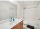 Bright bathroom with a sink, a tub with shower, and white-painted walls at 13 Pegram Ct, Durham, NC 27703
