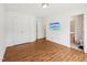 Bedroom featuring modern flooring, a wall-mounted TV, and a glimpse into a bathroom at 13 Pegram Ct, Durham, NC 27703