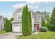Charming two-story home with a red front door and green evergreens at 13 Pegram Ct, Durham, NC 27703