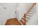 Bright foyer with wood floors, white walls, and a staircase to the upper level at 13 Pegram Ct, Durham, NC 27703