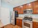 Kitchen featuring stainless appliances, wooden cabinets, and light countertops at 13 Pegram Ct, Durham, NC 27703