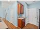 A kitchen area features wooden cabinets, light countertops, and is adjacent to a hallway and staircase at 13 Pegram Ct, Durham, NC 27703