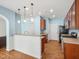 Open kitchen with wooden cabinets, countertops, stainless steel appliances, and stylish pendant lighting at 13 Pegram Ct, Durham, NC 27703