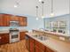 Kitchen with stainless steel appliances, wood cabinets, and a breakfast bar looking into the dining area at 13 Pegram Ct, Durham, NC 27703
