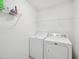 Functional laundry room with washer, dryer, and wire shelving for organized storage at 13 Pegram Ct, Durham, NC 27703