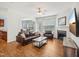 Comfortable living room with fireplace, ceiling fan, and view to the dining area at 13 Pegram Ct, Durham, NC 27703