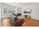 Cozy living room with a fireplace, hardwood floors, and natural light from a door to outside at 13 Pegram Ct, Durham, NC 27703