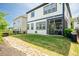 A scenic backyard with a lush lawn, stone features, and a screened-in porch at 134 Cotten Dr, Morrisville, NC 27560